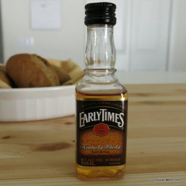 Small bottle of Kentucky whisky on table.