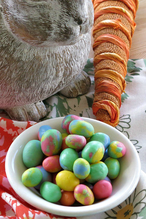 DIY Easter Egg Buttermints in a bowl with bunny and carrot in the background