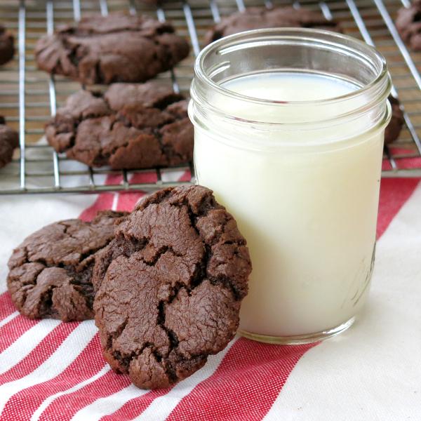 Two Molten Lava Chocolate Chip Cookies next to cup of milk