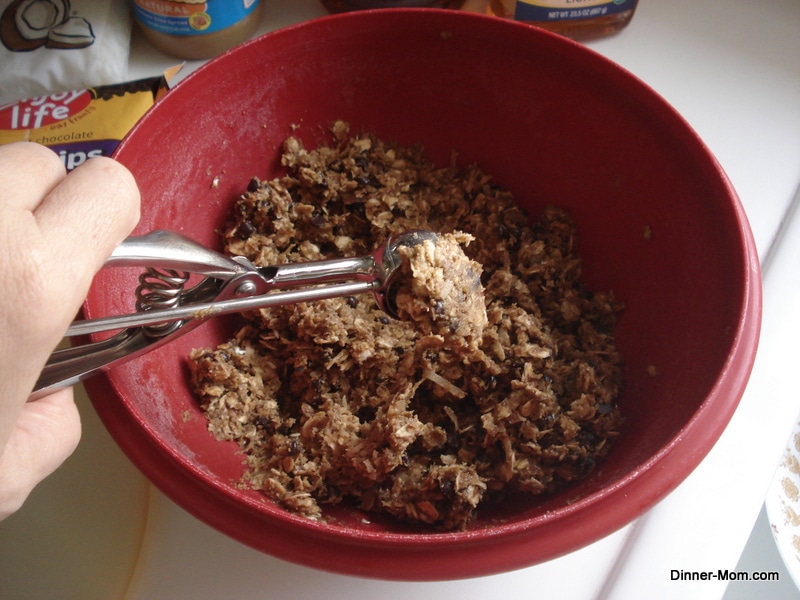 Scoop lifting Sunbutter Energy Ball batter out of the bowl