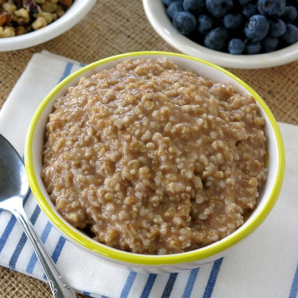 Bowl of cooked Steel Cut Oatmeal from a crockpot without any toppings.