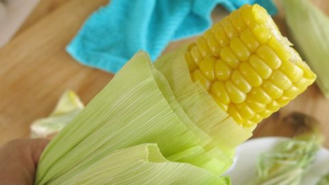 Microwave Corn on the Cob being pulled from husk