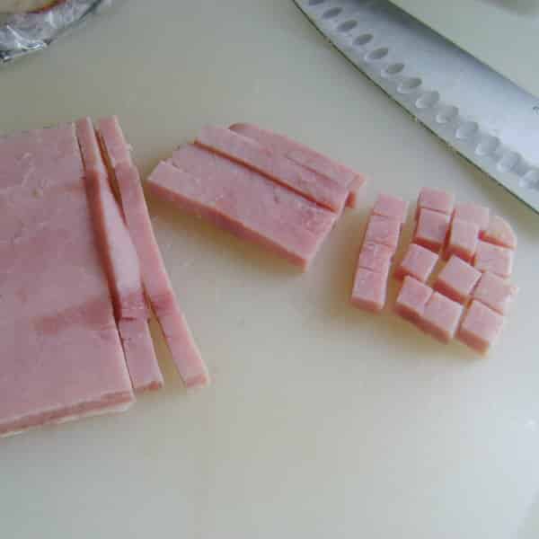 Cubed ham on a cutting board.