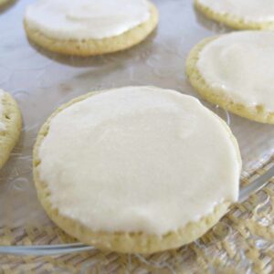 Key lime cookies topped with key lime icing on a platter.