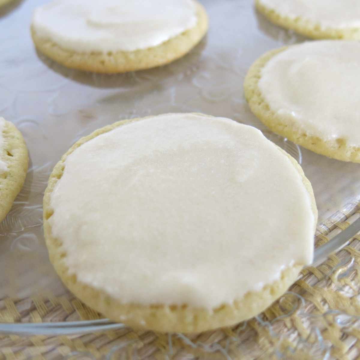 Key lime cookies topped with key lime icing on a platter.