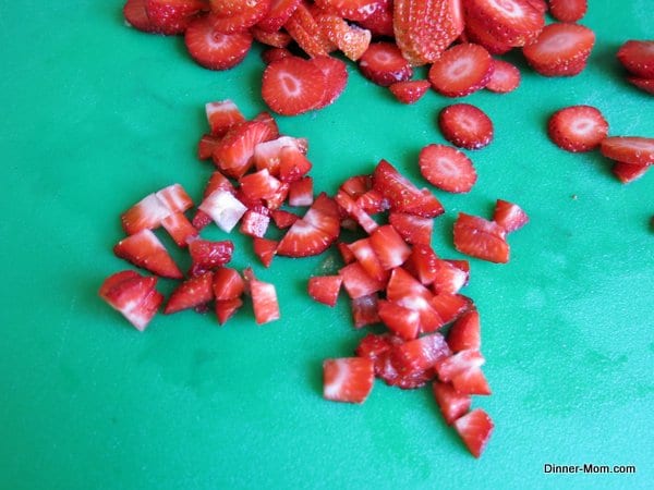 Diced strawberries on a cutting board
