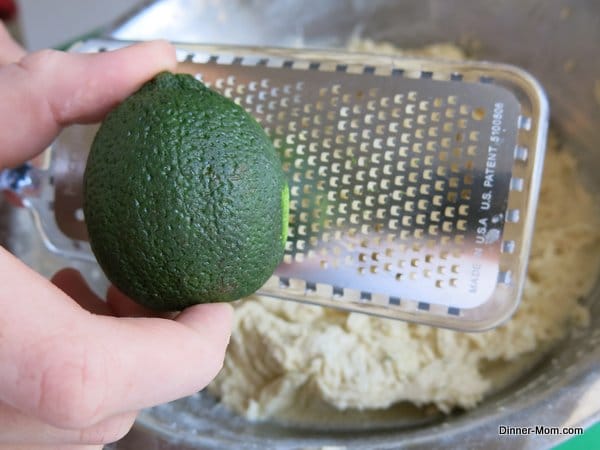 Lime being zested into a bowl