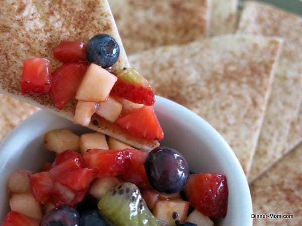 Cinnamon Chip dipping into bowl with Fruit Salsa