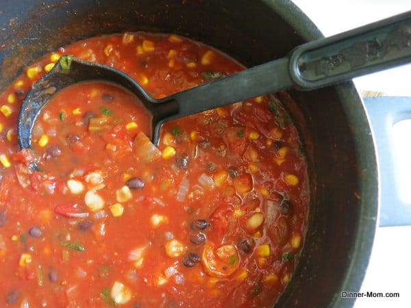 Seafood tortilla soup in a stock pot with ladel