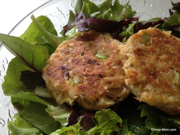 Maryland Style Lump Crab Cakes over Greens in bowl.