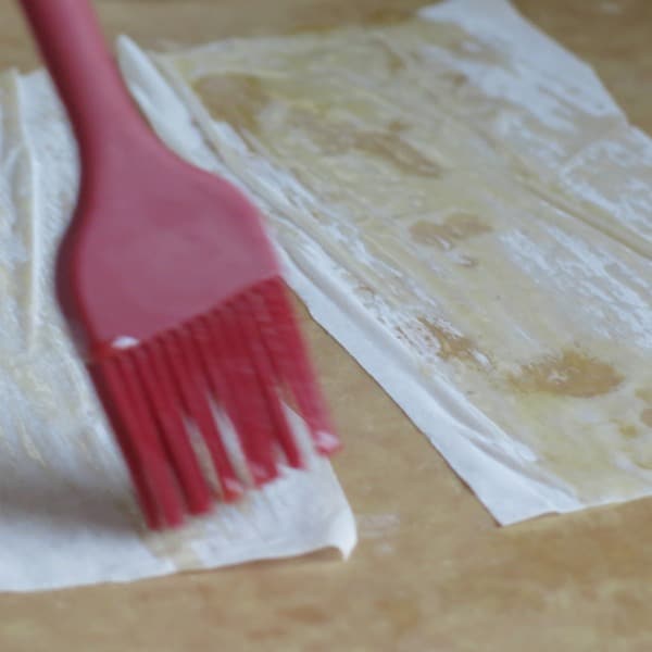 Phyllo Dough being brushed with butter.