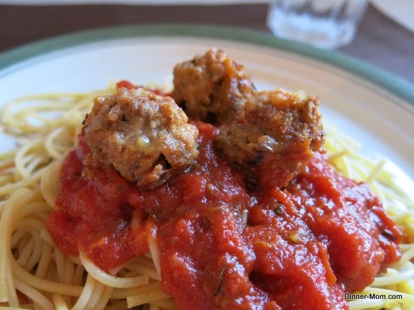 Meatballs from a Cake Pop Maker on top of spaghetti noodles and sauce