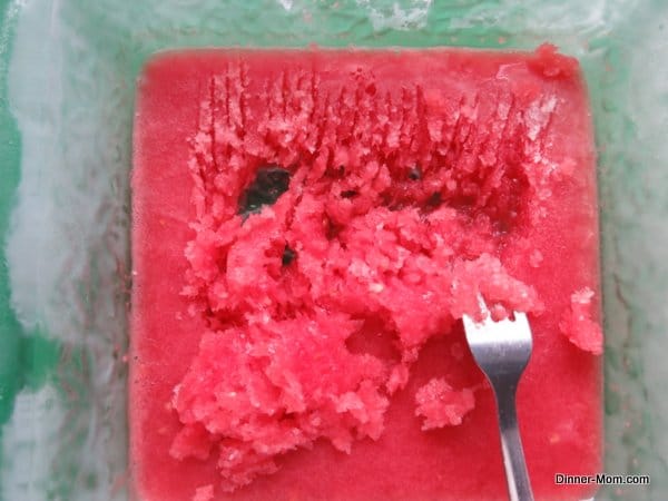 fork raking granita out of frozen watermelon