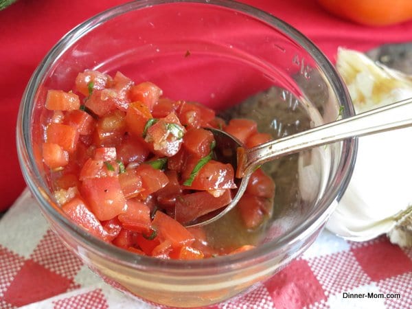 Easy Tomato Bruschetta in bowl with spoon.