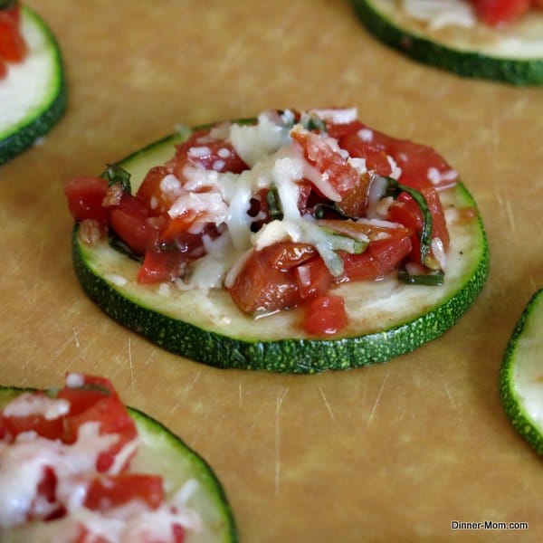 Zucchini Bruschetta round on a cutting board.
