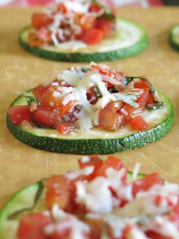 Upclose zucchini bruschetta on cutting board.