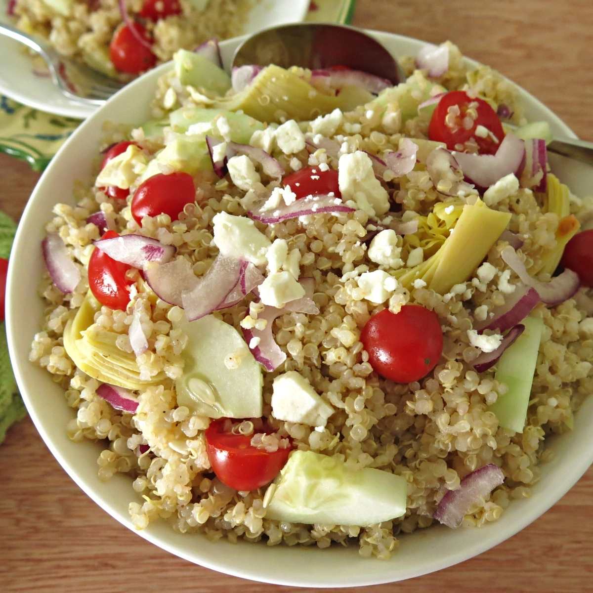 Greek quinoa salad with red wine vinaigrette in a serving bowl.