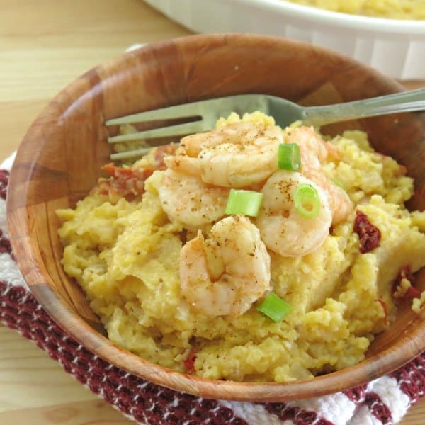 Skinn shrimp and grits in a bowl with a fork