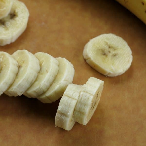 Sliced bananas on a cutting board.