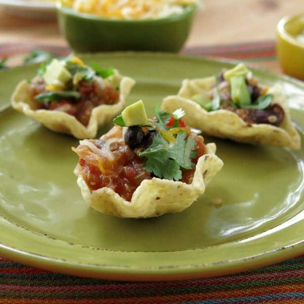 Three scoops with Crock-Pot Chicken Fajitas filling to make nachos