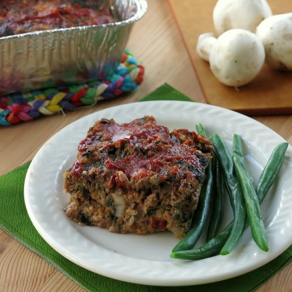 Slice of Healthy Meatloaf Recipe on a plate with green beans