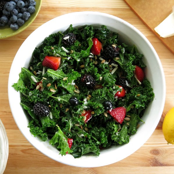 Massaged Kale Salad in bowl with berries