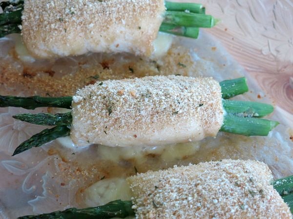 Asparagus wrapped chicken in baking dish