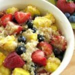 Quinoa fruit salad with honey lime dressing in a serving bowl.