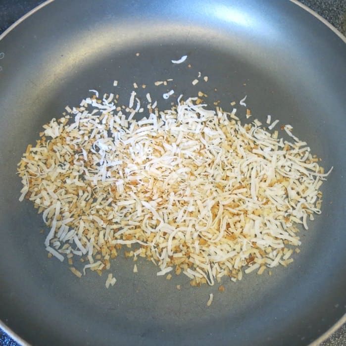 Toasted coconut in frying pan.