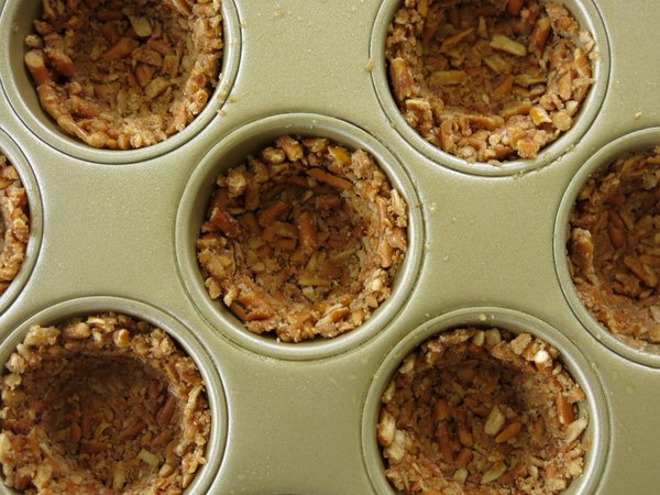 Pretzel crusts pressed into a muffin tip to make cups