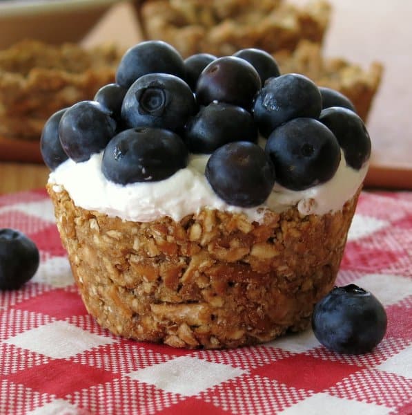 No-Bake Mini Cheesecakes topped with blueberries in a pretzel cup