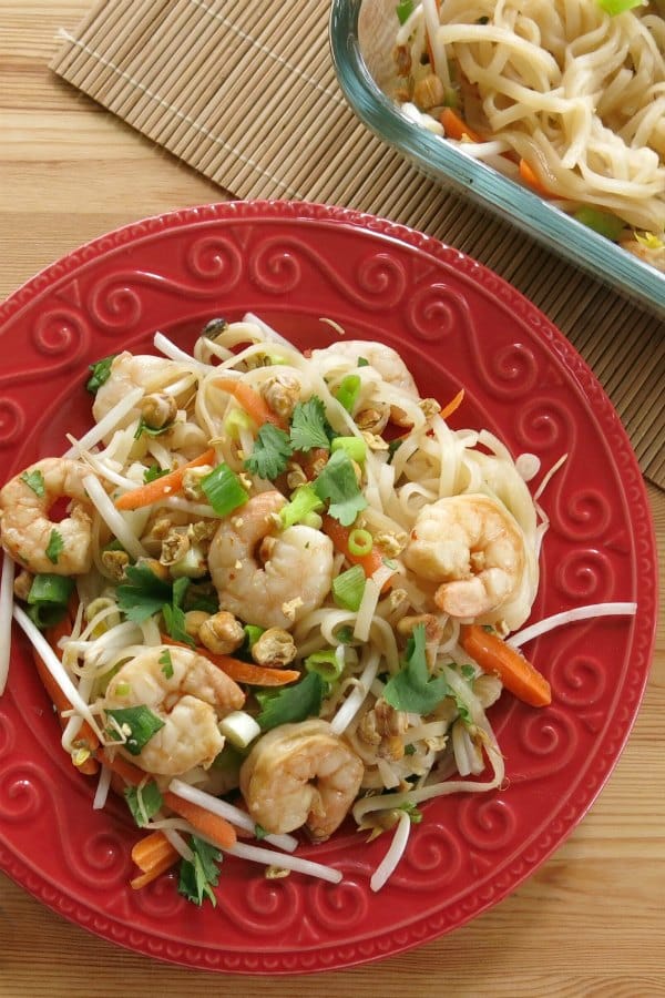 Overhead view of easy shrimp pad thai recipe on plate with baking dish in background