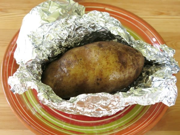 Baked Potato cooked in crock-pot in open aluminum foil