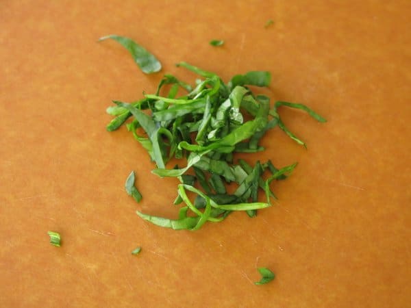 Chiffonaded spinach on cutting board