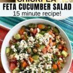 Chickpea feta cucumber salad with red onions, carrots, and tomatoes in a white bowl with a cucumber and bowl of feta behind it and text overlay that says chickpea feta cucumber salad, easy 15 minute recipe.