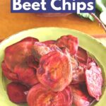 Oven-baked beet chips on a plate with a raw red beet behind it.