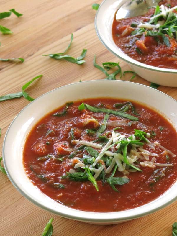 Easy Tomato Florentine with Pasta Soup on cutting board.