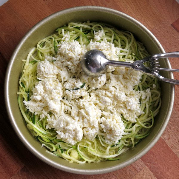 Scoops of 3 cheese mixture on zucchini noodles