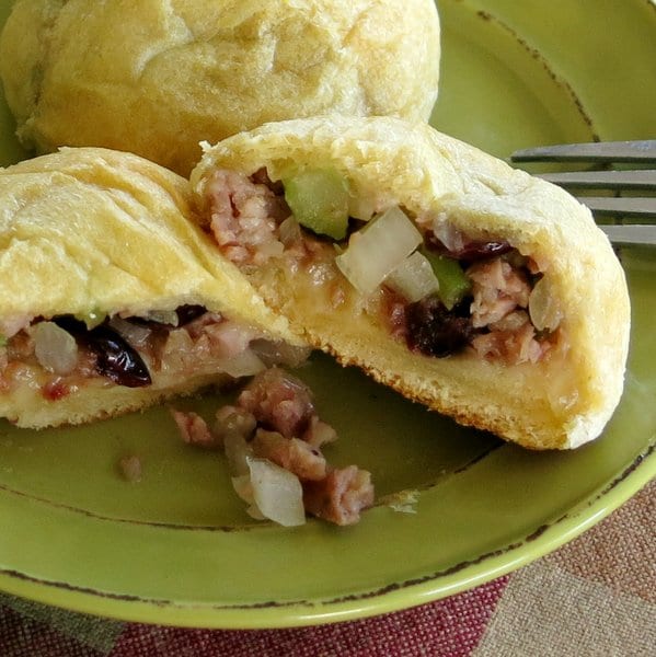 Easy Sausage Stuffing Balls in crescent roll dough cut in half on plate