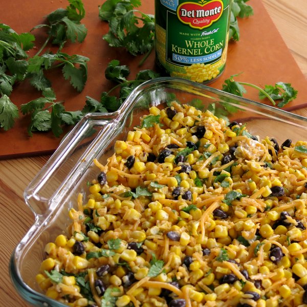 Tex Mex Cheddar Corn Casserole Recipe in baking dish with can or corn in the background