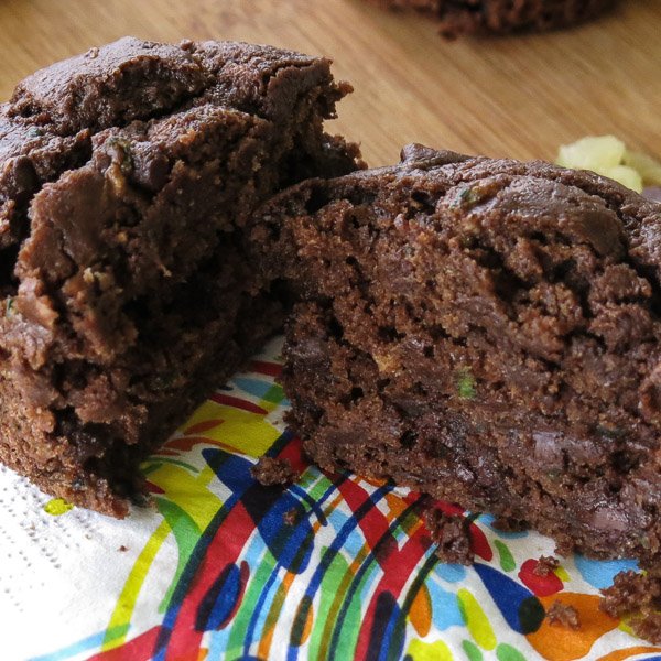 Healthy Death by Chocolate Zucchini Muffin cut in half on a napkin