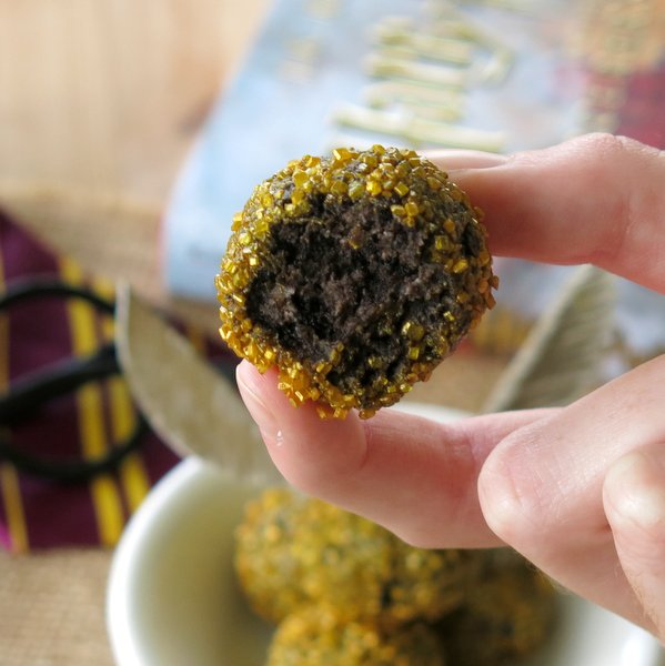 Hand taking a bite out of Harry Potter Golden Snitch Truffle.