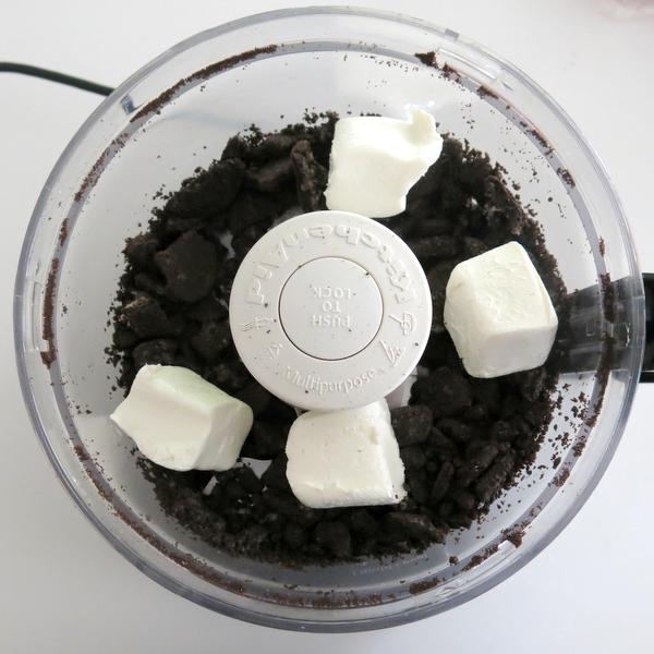 Oreos and cream cheese in a food processor.