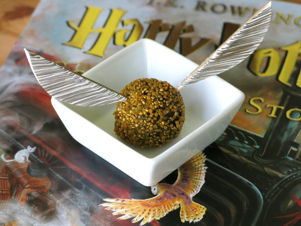 Wings inserted into a Golden Snitch Truffle ball.