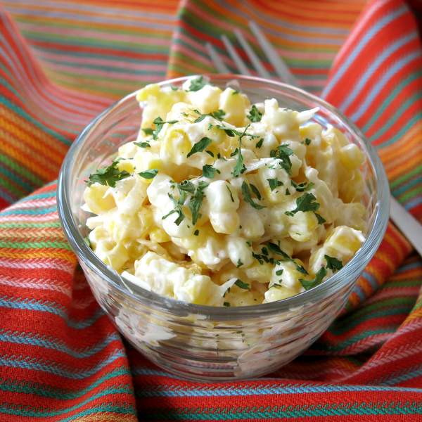 Elote in a small glass bowl