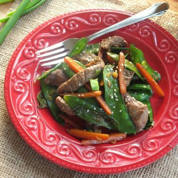 Sesame beef stir fry on plate with fork