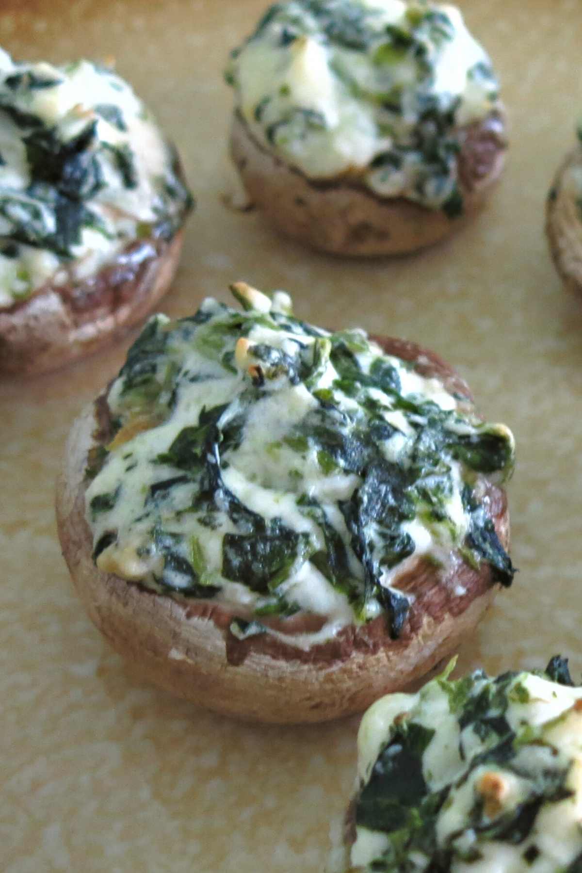 Platter of stuffed mushrooms with cream cheese and spinach.