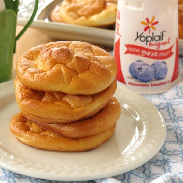 Stack of blueberry cloud bread on plate with Yoplait container behind it