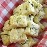 Cauliflower Pizza Bites in a basket lined with a red and white checkered napkin