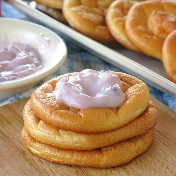 Blueberry Cloud Bread Danishes stacked with yogurt and bread rounds in the background